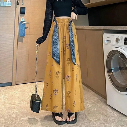 Meadow | Splývavé kalhoty palazzo s botanickým vzorem